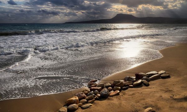 Crete sea coastline, sunset, water blue, sand.