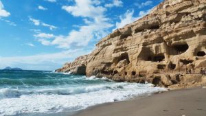 Matala Caves with a sunny day and waves